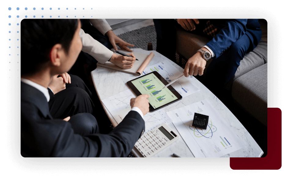 Business professionals discussing ideas using a tablet during a meeting.